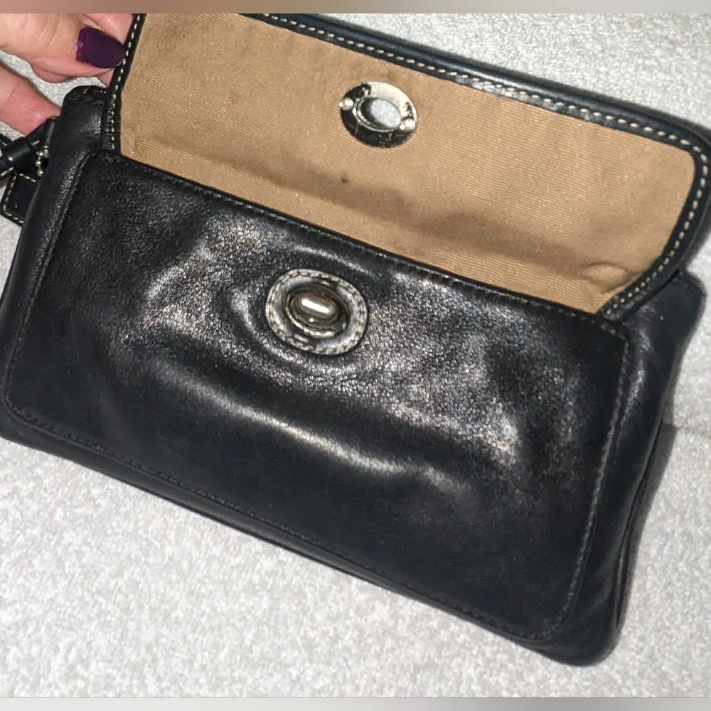Coach black leather turn lock flap wristlet.